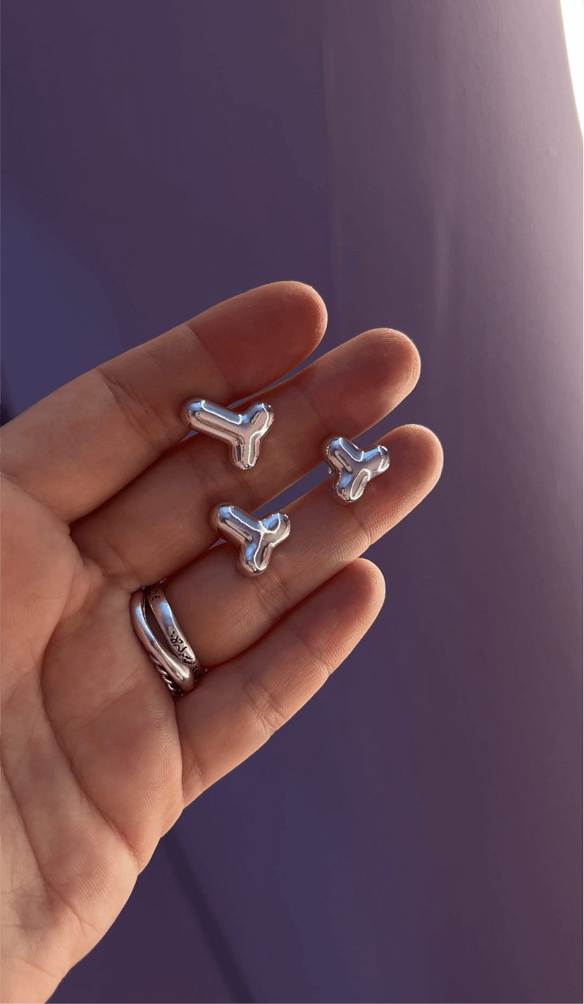 Silver stud earring penis design, bold statement accessory