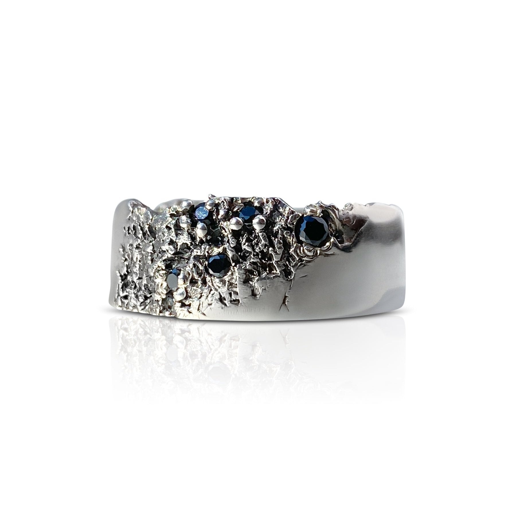 ring in silver, combining brutalist style with minimalist details.