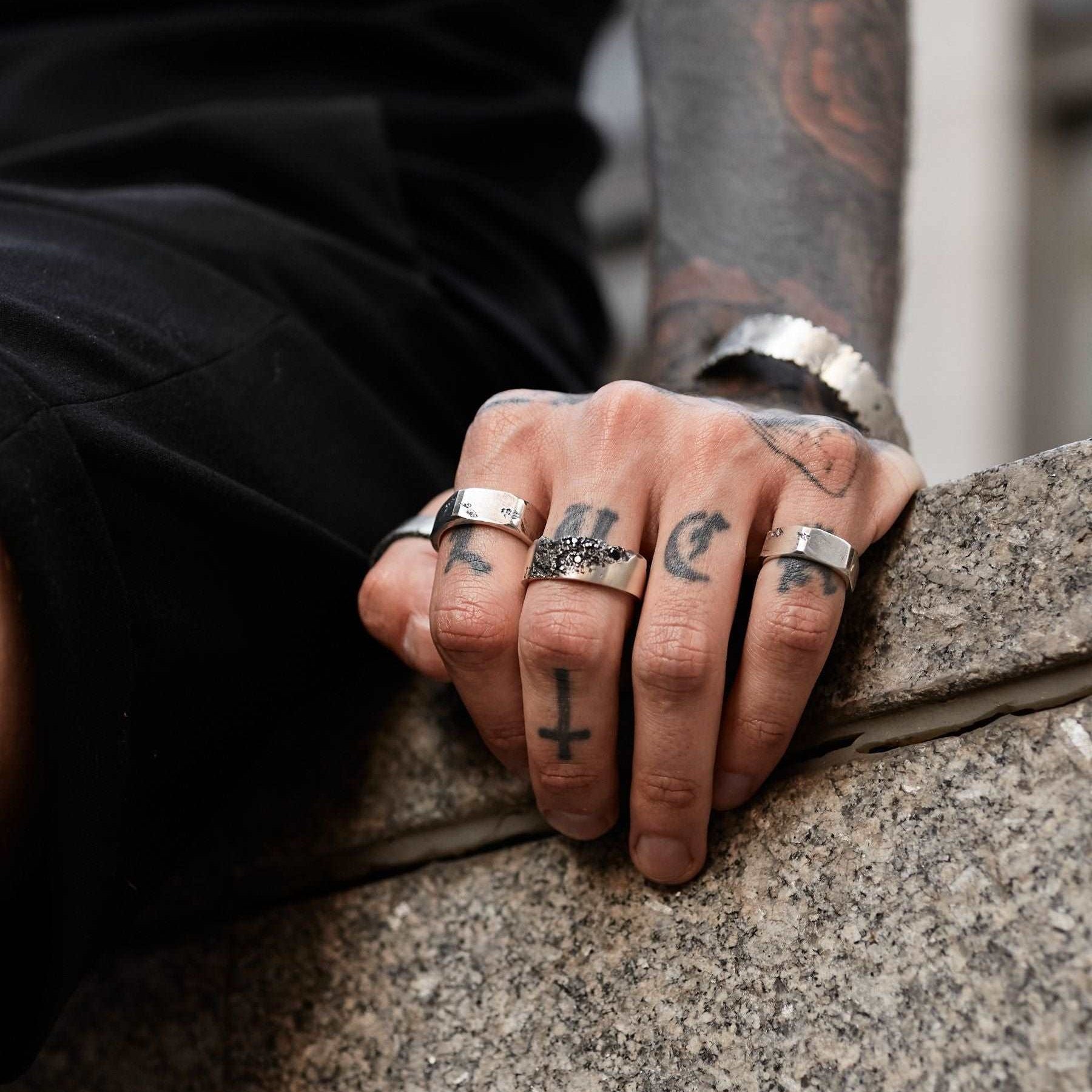 Brutalist men’s ring crafted with black stone accents for a striking look.