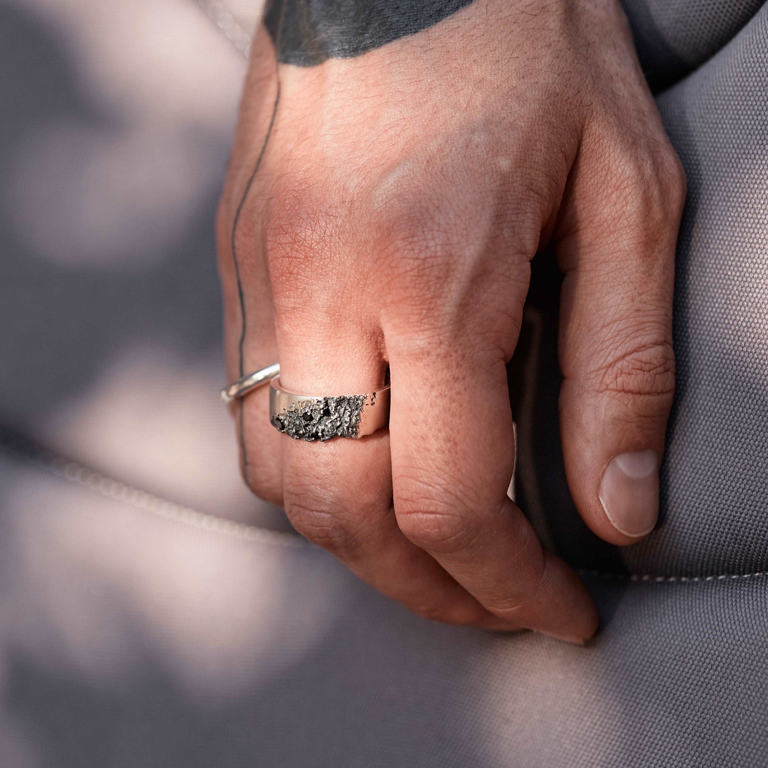 Black spinel ring for men with a unique and irregular shape.