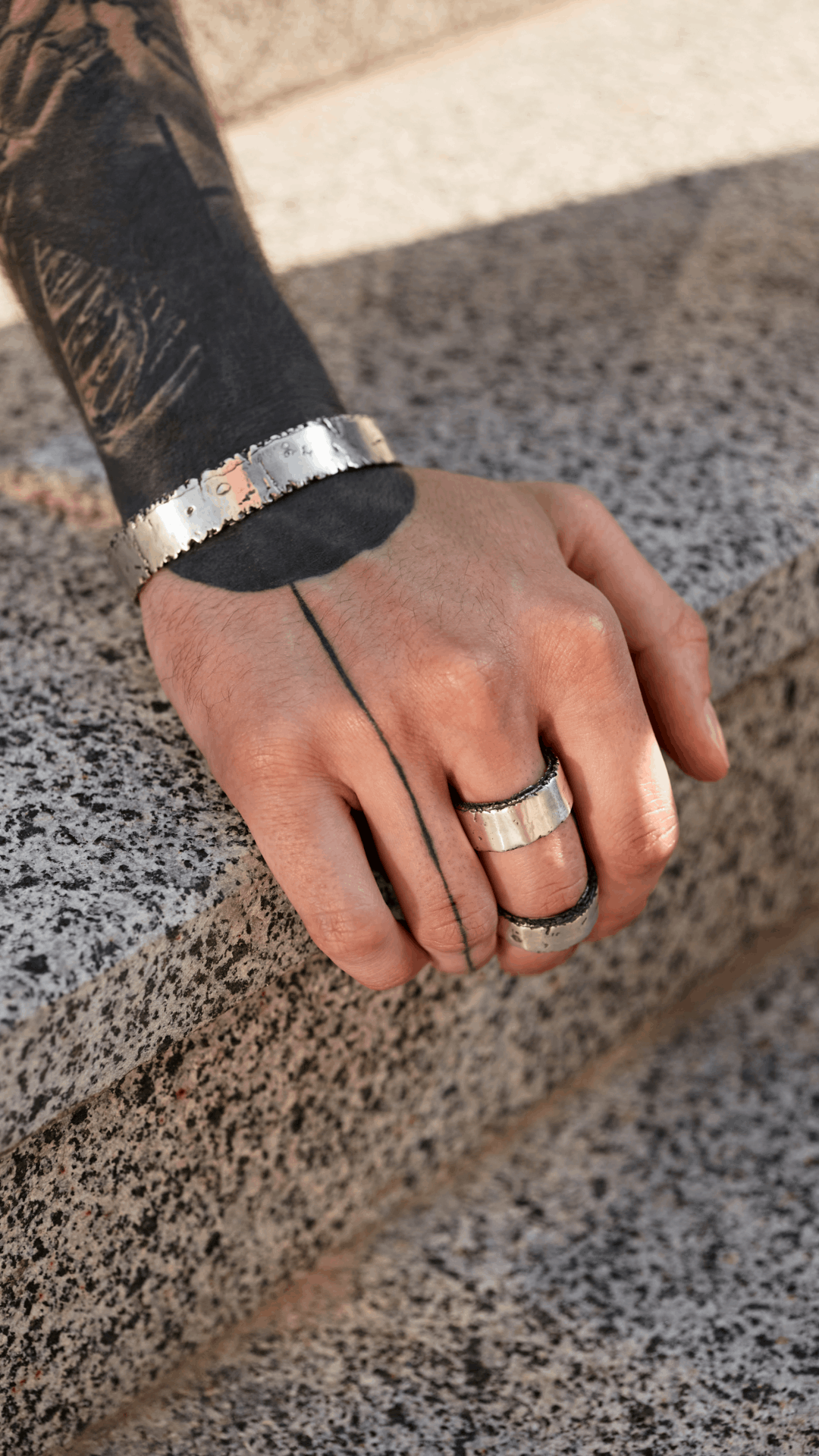 Handcrafted sterling silver ring with distinctive irregular textures.