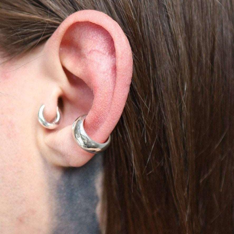 Sterling silver low domed cuff earring with a sleek finish.