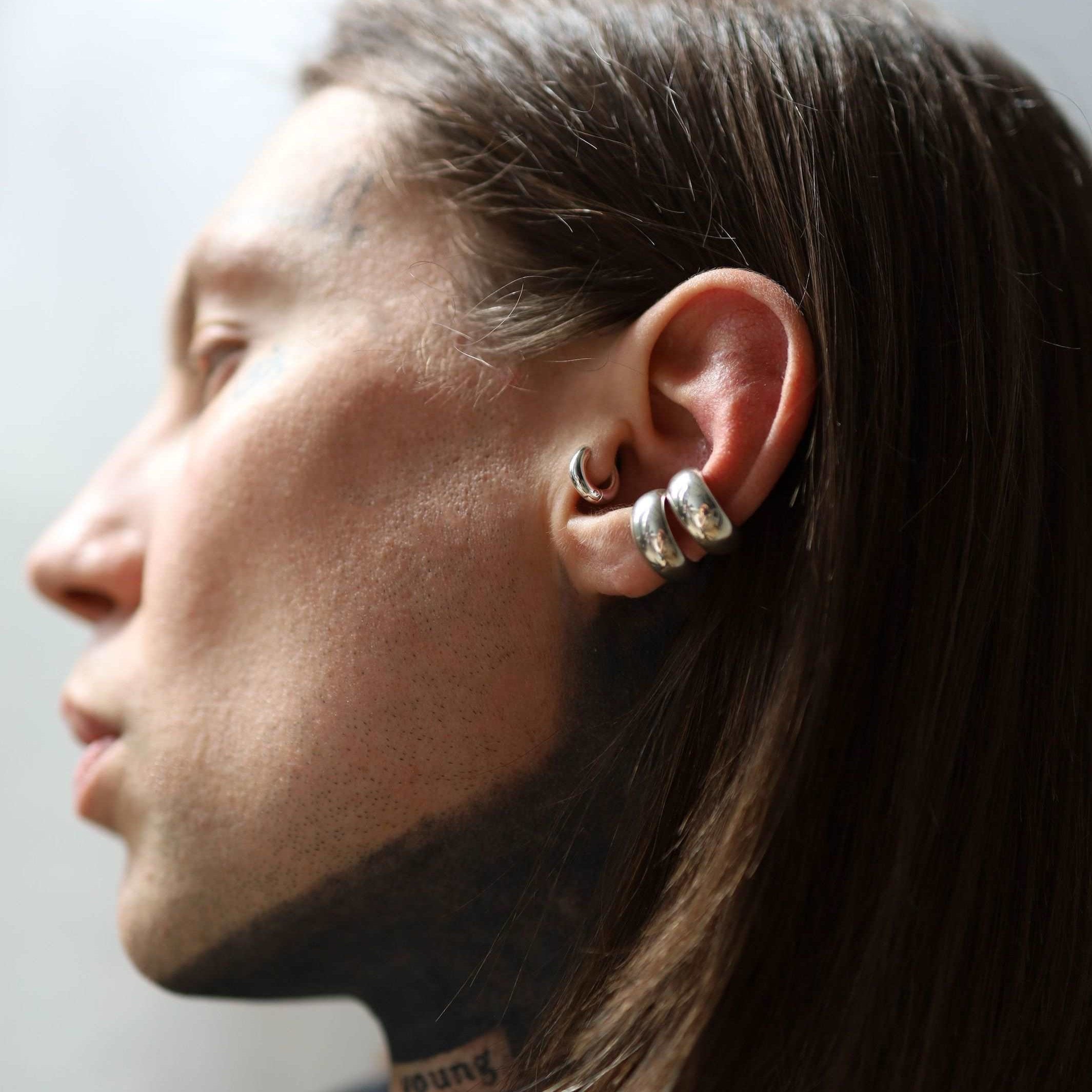 Chunky silver cuff earring with a low domed shape.