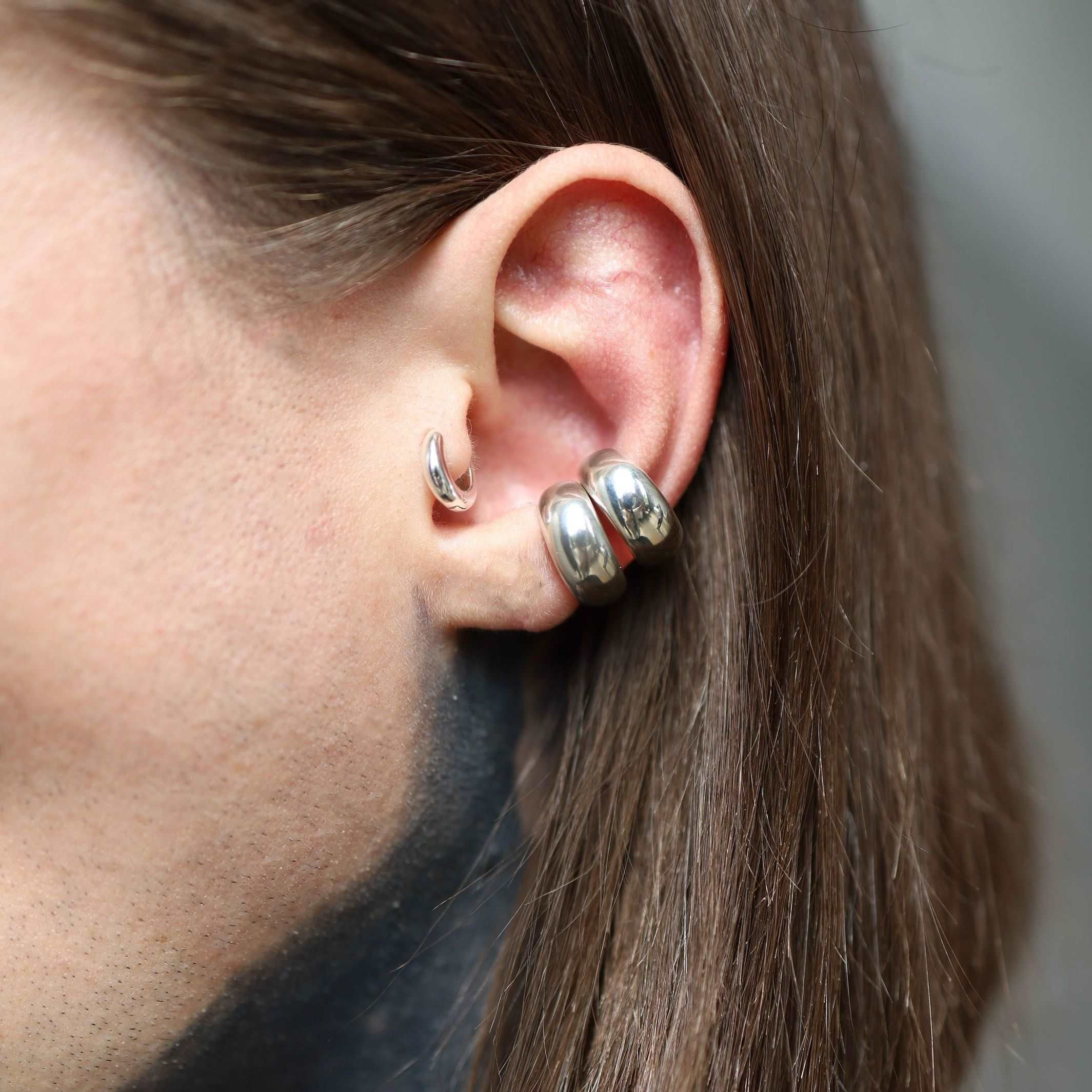 Modern sterling silver ear cuff with a chunky, low domed design.