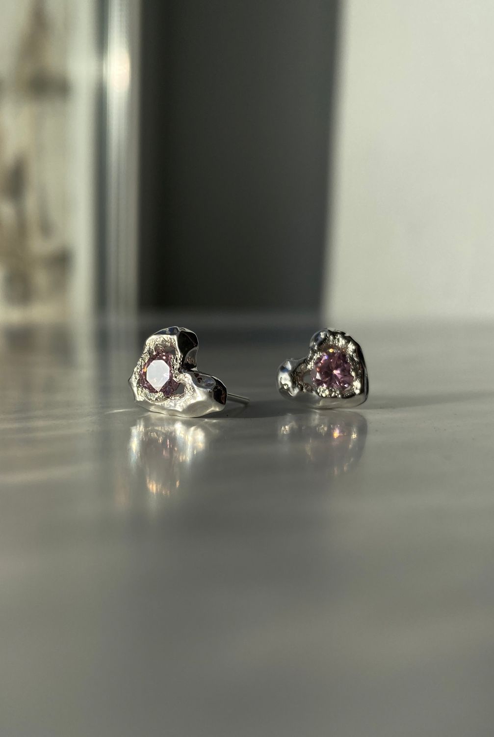 Silver earrings with pink stones, adding charm and elegance to any look.