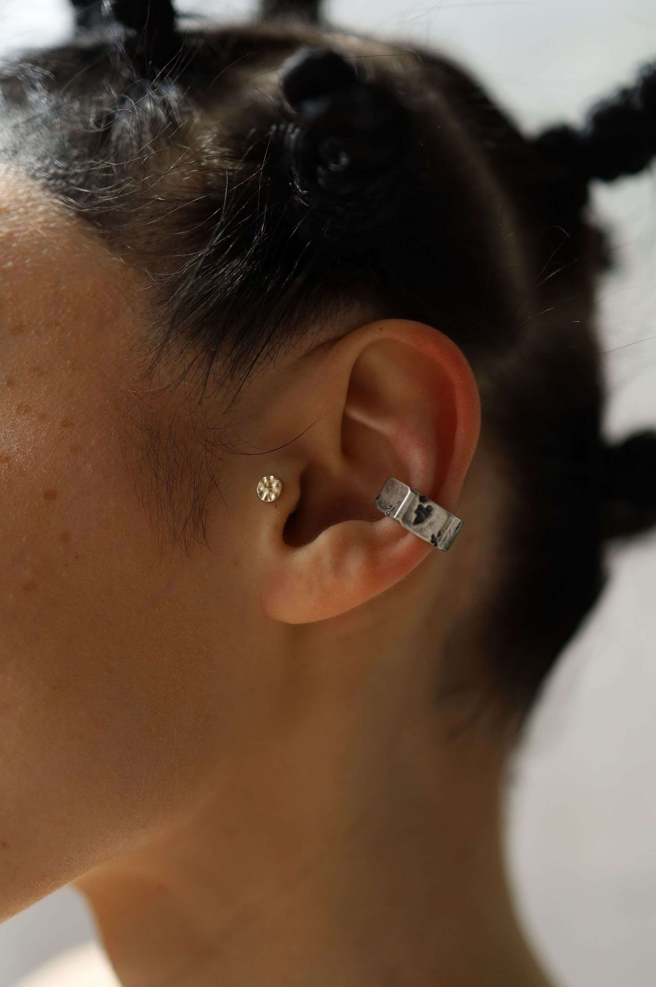 Chunky silver ear accessory with unique architectural elements and edgy contemporary aesthetic