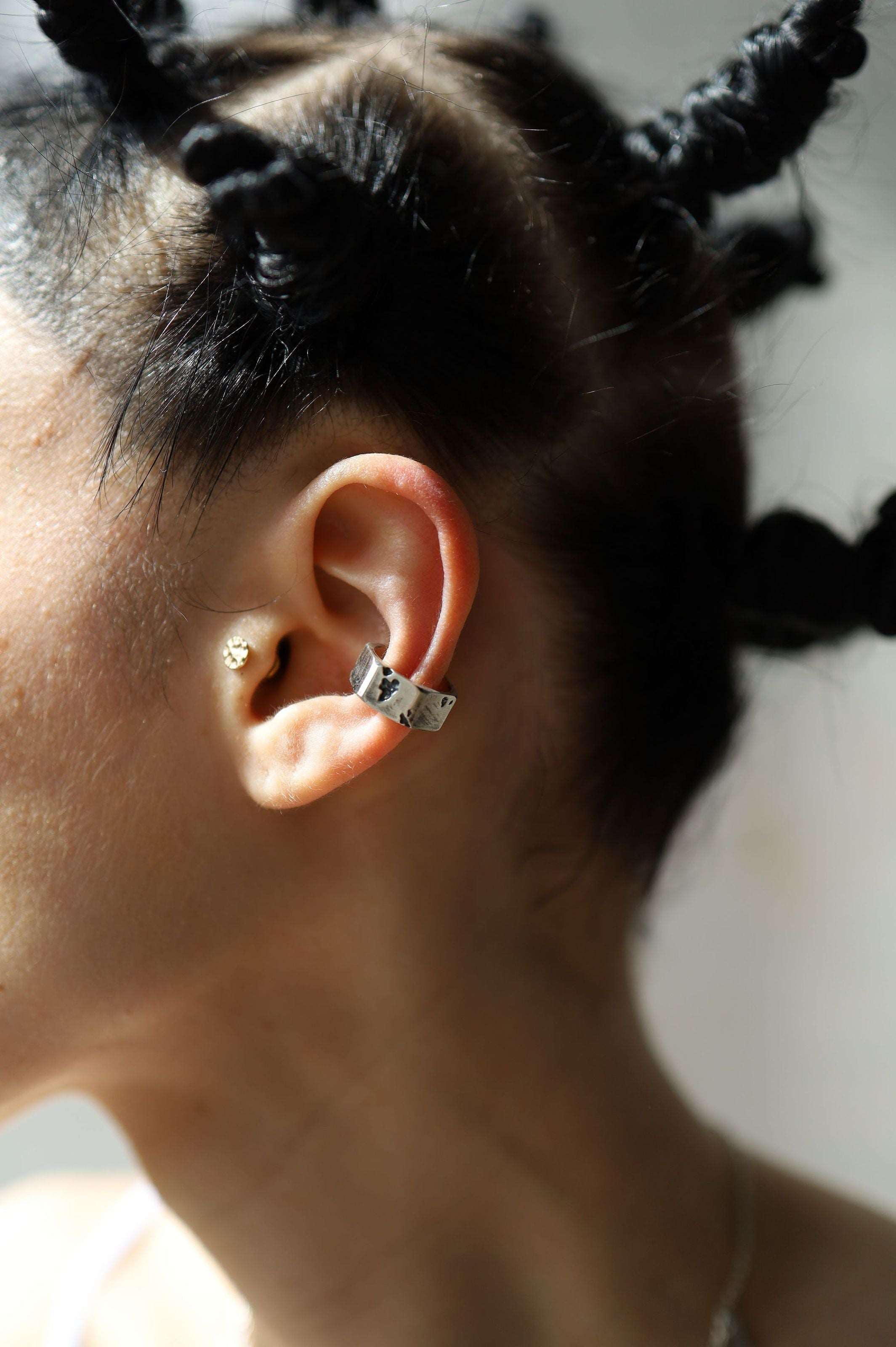 Bold geometric ear cuff featuring industrial-inspired screw nut design for modern minimalist style