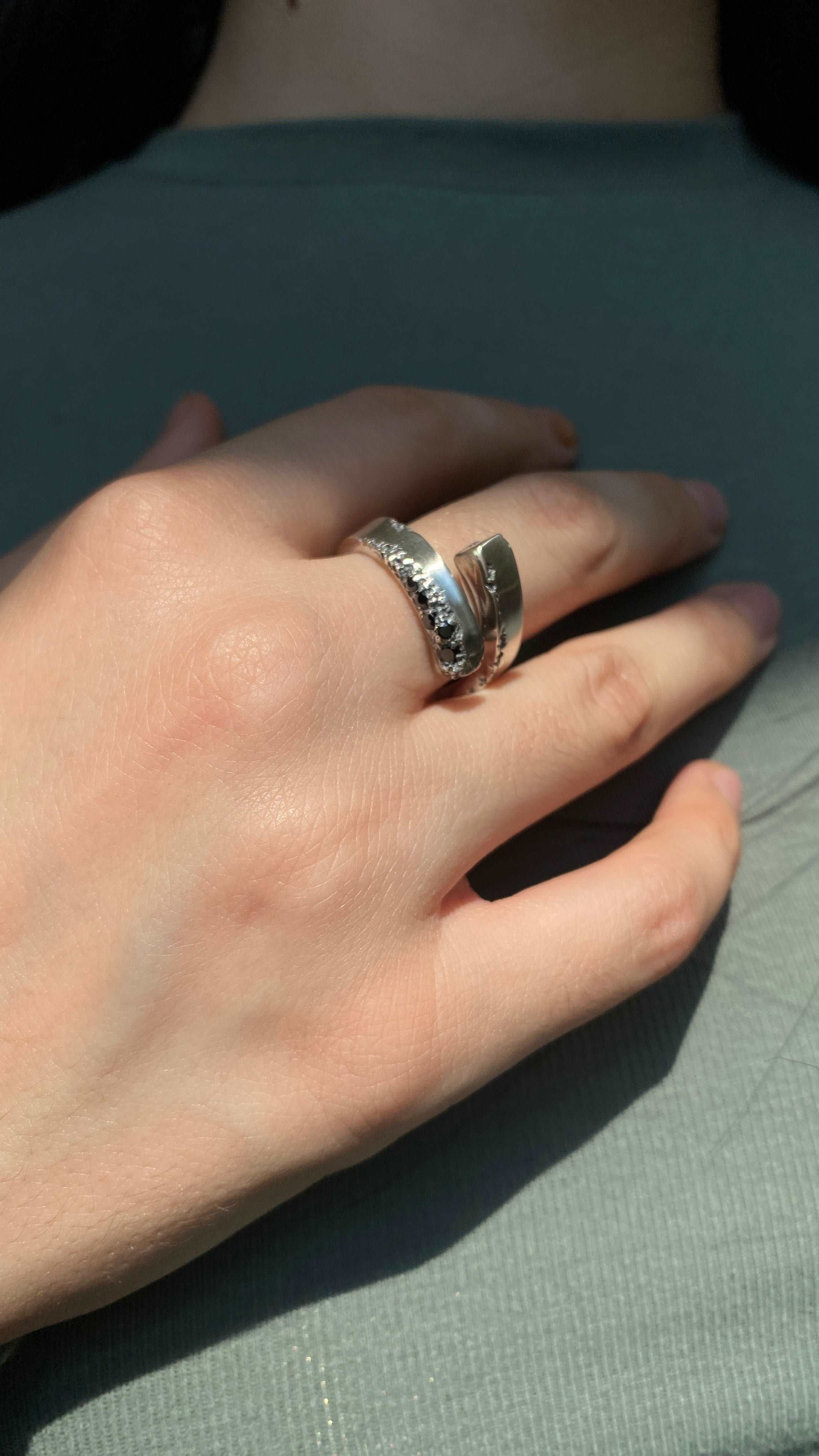 Stylish silver open ring with a black spinel gemstone, perfect as a gift.