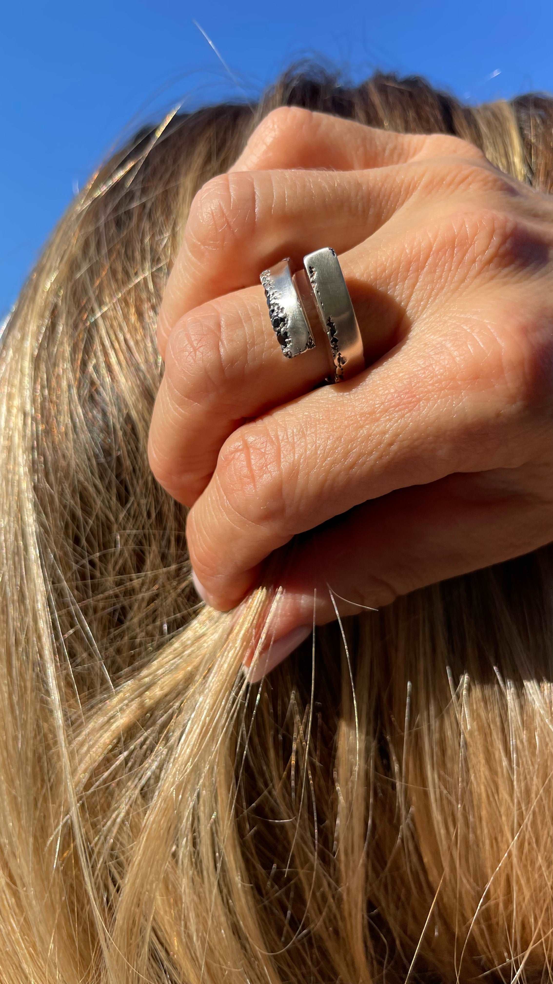 Beautifully crafted silver ring featuring a sleek open design and black spinel.