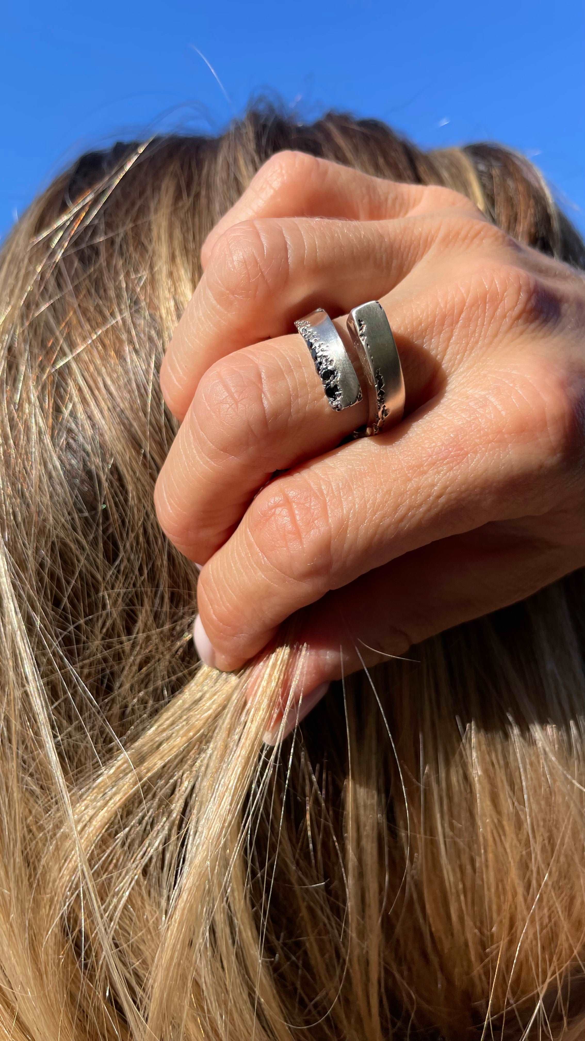 Handcrafted silver open ring with an elegant design and black spinel accents.